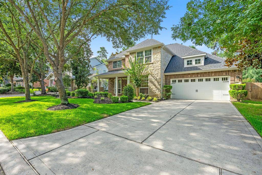Charming Curb Appeal: This inviting two-story home boasts a beautifully manicured lawn and mature trees, nestled in a serene neighborhood.