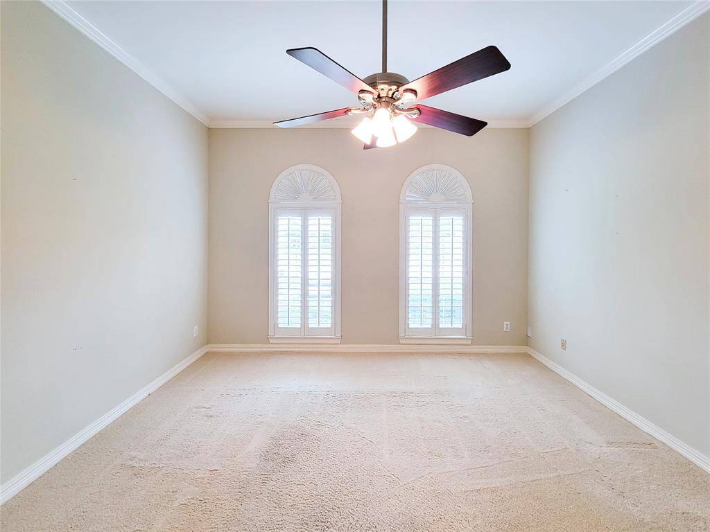 Flex room showing tall arched windows that overlook front yard