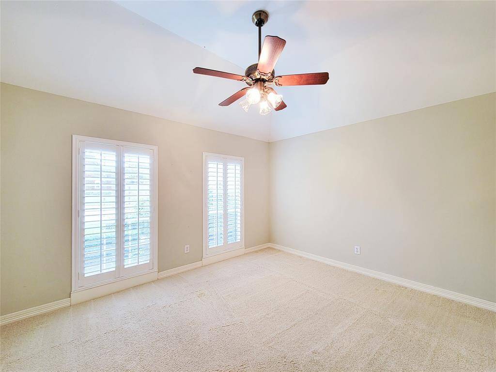 Secondary Bedroom with tall windows that faces front of house, detailed ceiling