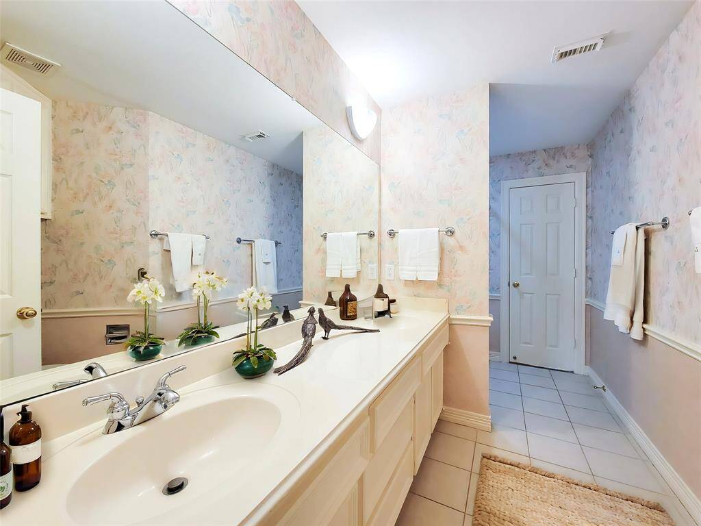 Pass-through Hall Bath showing long vanity with double sinks