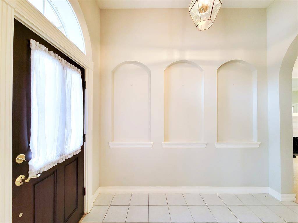 Welcome & please come in! A view from the Dining Room looking at Entry just inside Front Door. Mahogany solid wood Front Door, Detailed Millwork