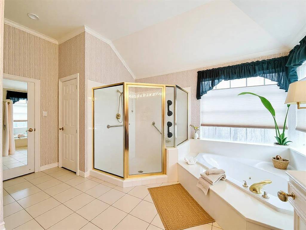 another view of Primary Bath, huge walk-in closet behind mirrored door, toilet closet behind shower.
