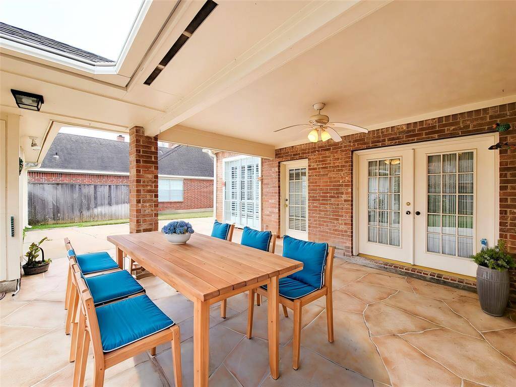 Another view of Patio, kitchen single-entry kitchen door, double French doors into Living room