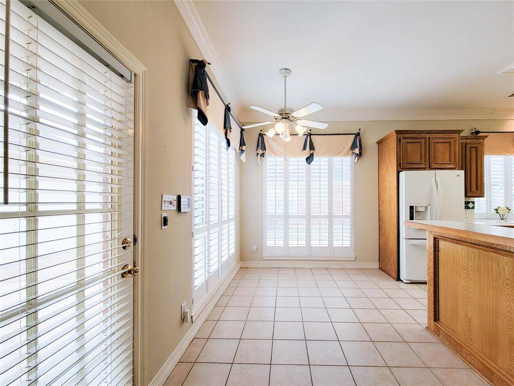 Just inside the patio door, cheery eat-in Breakfast area. Bright natural light in the kitchen, large windows with plantation shutters, crown molding