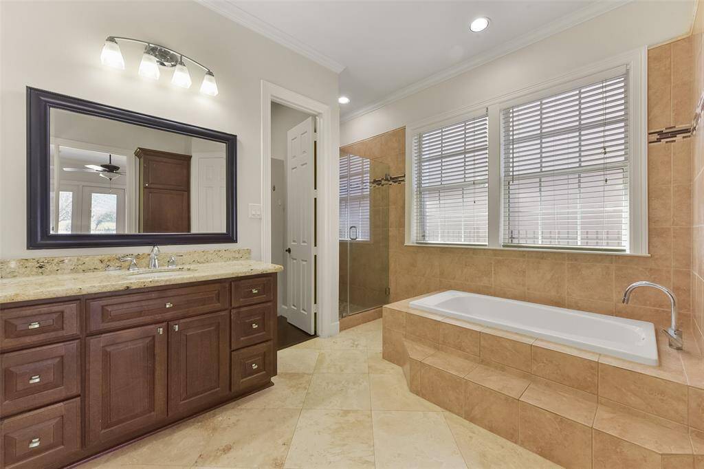YOUR EN-SUITE BATH FEATURES TWO WALK-IN CLOSETS A WALK-IN SHOWER AND A SOAKING TUB.