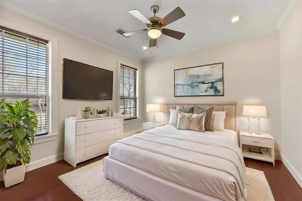 STYLISH GUEST BEDROOM WITH CROWN MOLDING, A CEILING FAN. **This room has been virtually staged.