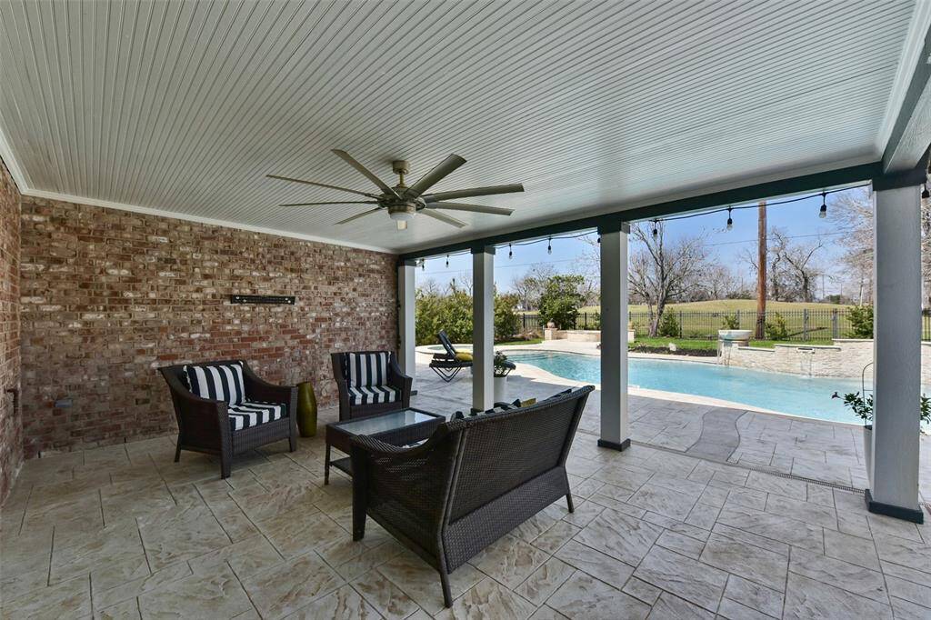 HOME OFFERS A RELAXING OUTDOOR SPACE WITH A SPACIOUS COVERED PATIO, PERFECT FOR ENTERTAINING OR UNWINDING.