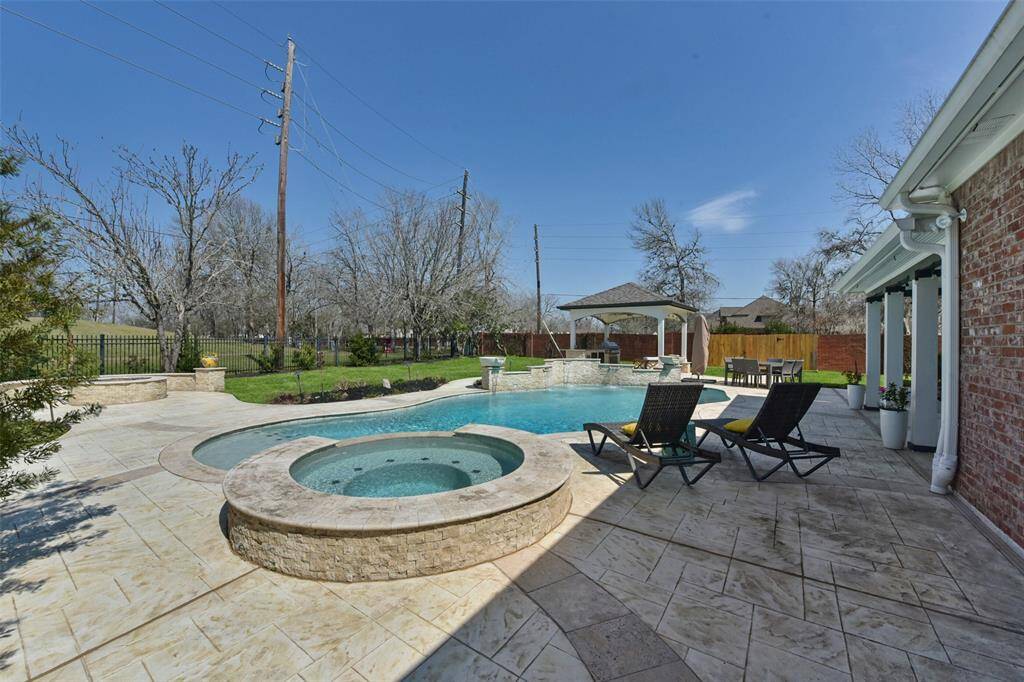 RESORT-STYLE POOL WITH A SOOTHING SPA, CREATING A PRIVATE OASIS RIGHT IN YOUR BACKYARD.