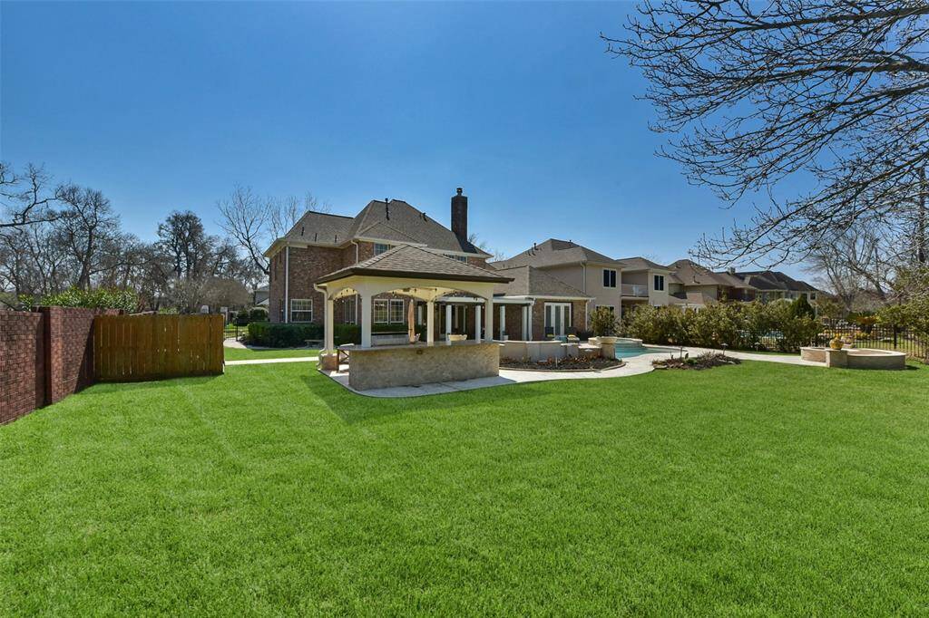ENJOY THE ULTIMATE BACKYARD EXPERIENCE WITH A STUNNING POOL, HOT TUB, WATER FEATURES, AND PLENTY OF LOUNGING SPACE.