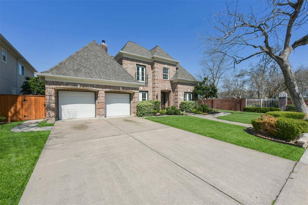 SPACIOUS DRIVEWAY LEADING TO A CONVENIENT 2-CAR GARAGE WITH AMPLE STORAGE.