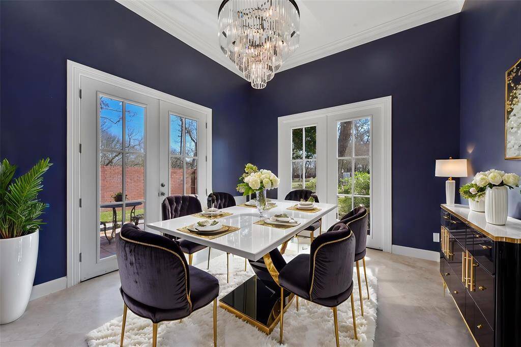 SOPHISTICATED FORMAL DINING WITH CRYSTAL CHANDELIER, AND FRENCH DOORS LEADING OUTSIDE. **This room has been virtually staged.
