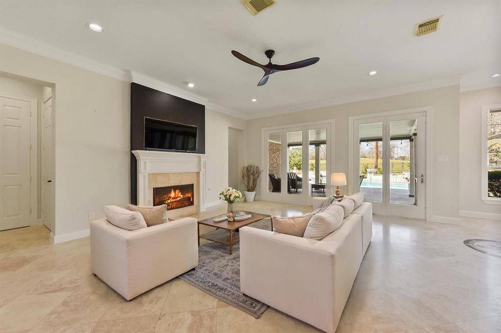 SPACIOUS FAMILY ROOM WITH A COZY FIREPLACE, BUILT-IN MEDIA CENTER , AND OPEN FLOW TO THE KITCHEN. **This room has been virtually staged.