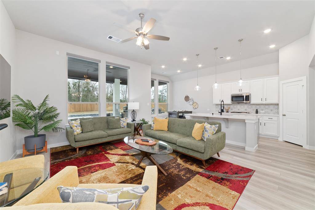 The living room is open to the kitchen with beautiful sunlight that makes this space a comfortable place to relax.