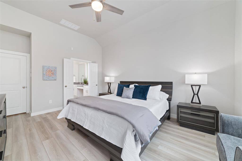This primary bedroom is both spacious and cozy.