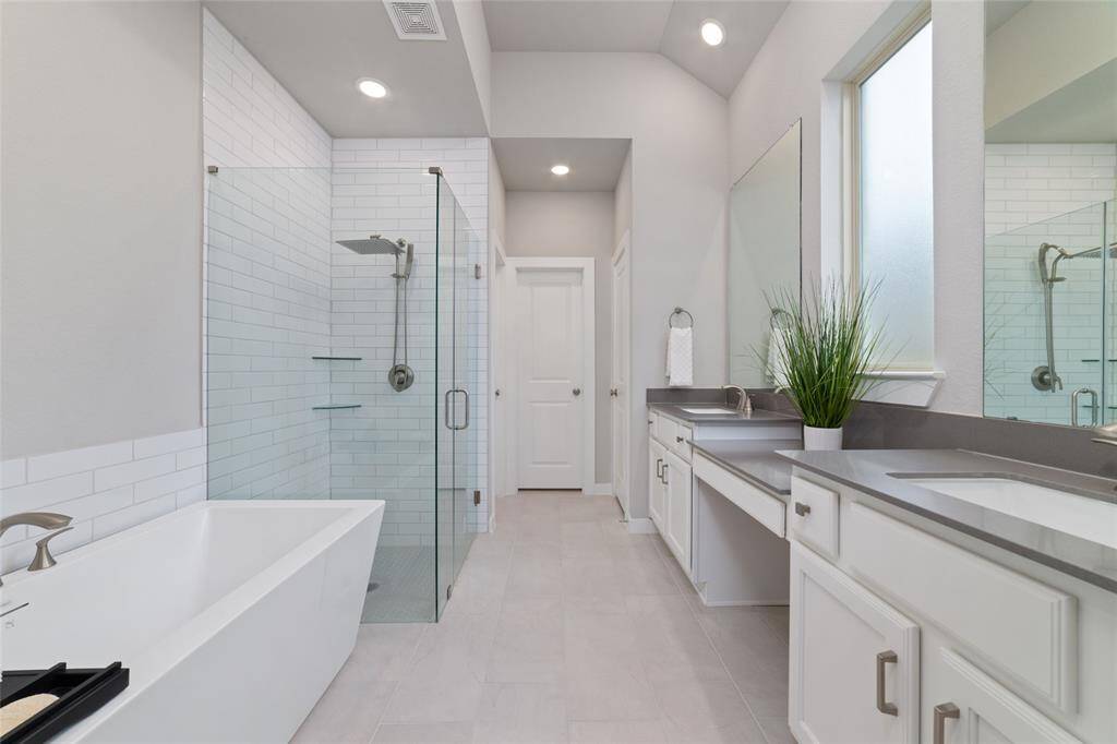 Seamless glass shower adds elegance to this bathroom.