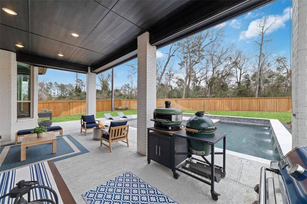 Huge patio to fully enjoy your outdoor space that offers plenty of yard, backdrop of trees, and a stunning pool.