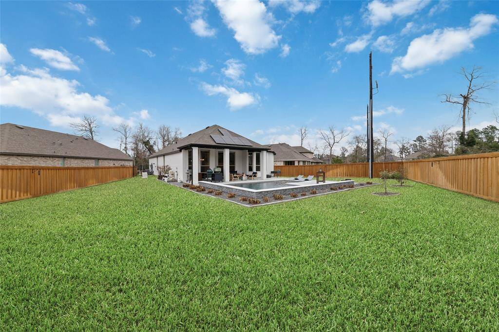 This home has plenty of yard space to do with what you wish. (Grass color has been enhanced.)