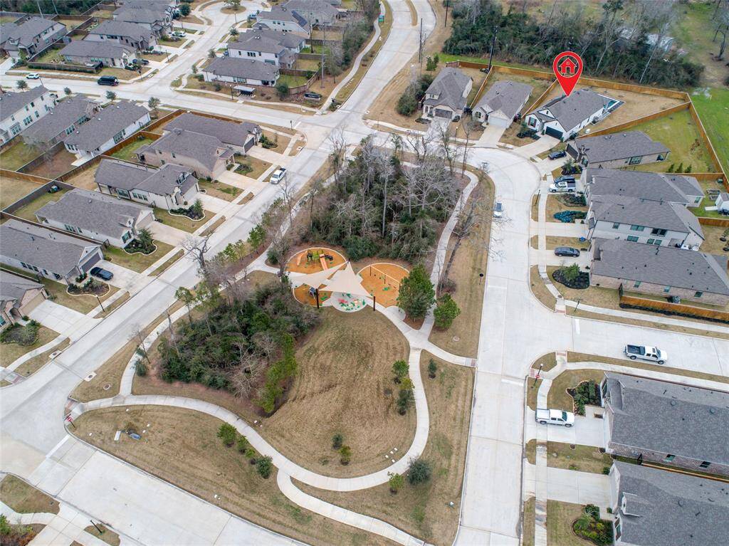 Wooded lot in front of home holds a playground that is steps away from the front door.