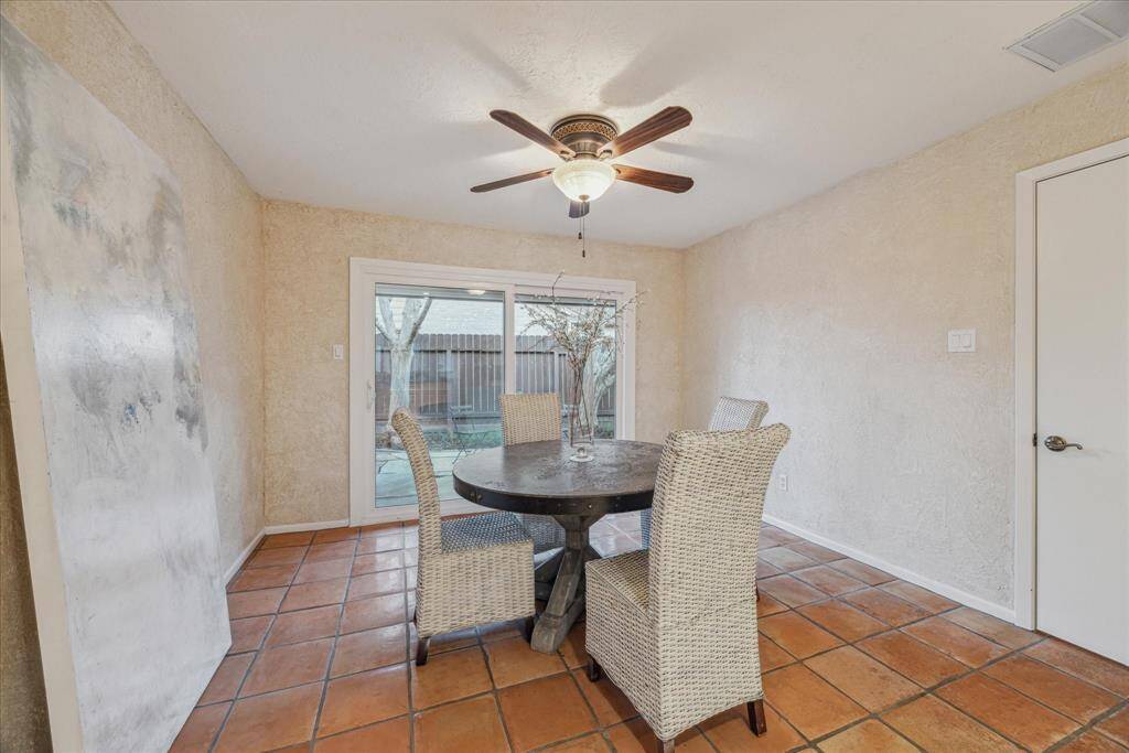 This sunny breakfast room is east facing and enjoys the views of the outdoor patio.  Perfect spot to start the day.  Utility room and walk-in pantry room to the right.