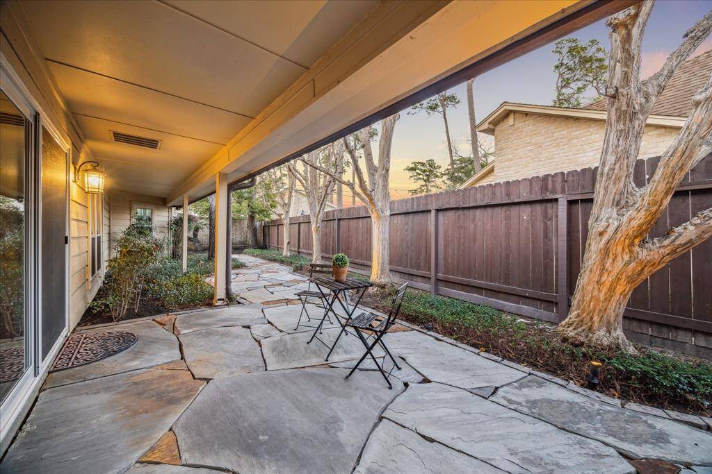 The charming covered patio just outside the breakfast room gets dramatic at night with the landscape lighting.