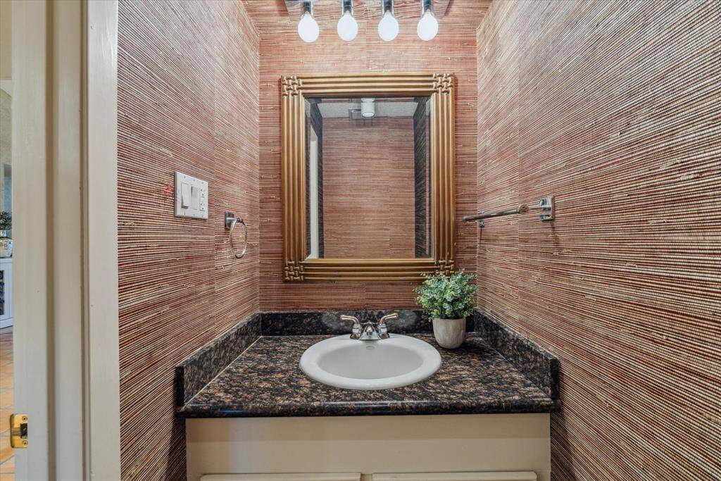 Powder bath located in the living area with designer grass cloth.