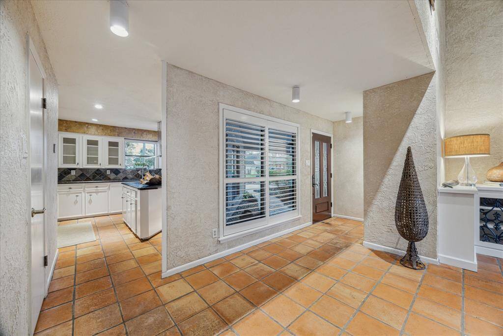 Spacious entry with half bath discreetly tucked off to the left.