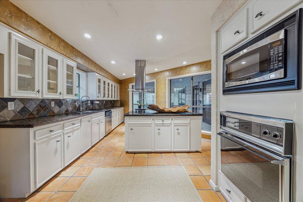 This roomy kitchen has it all. Plenty of cabinets and counter space.