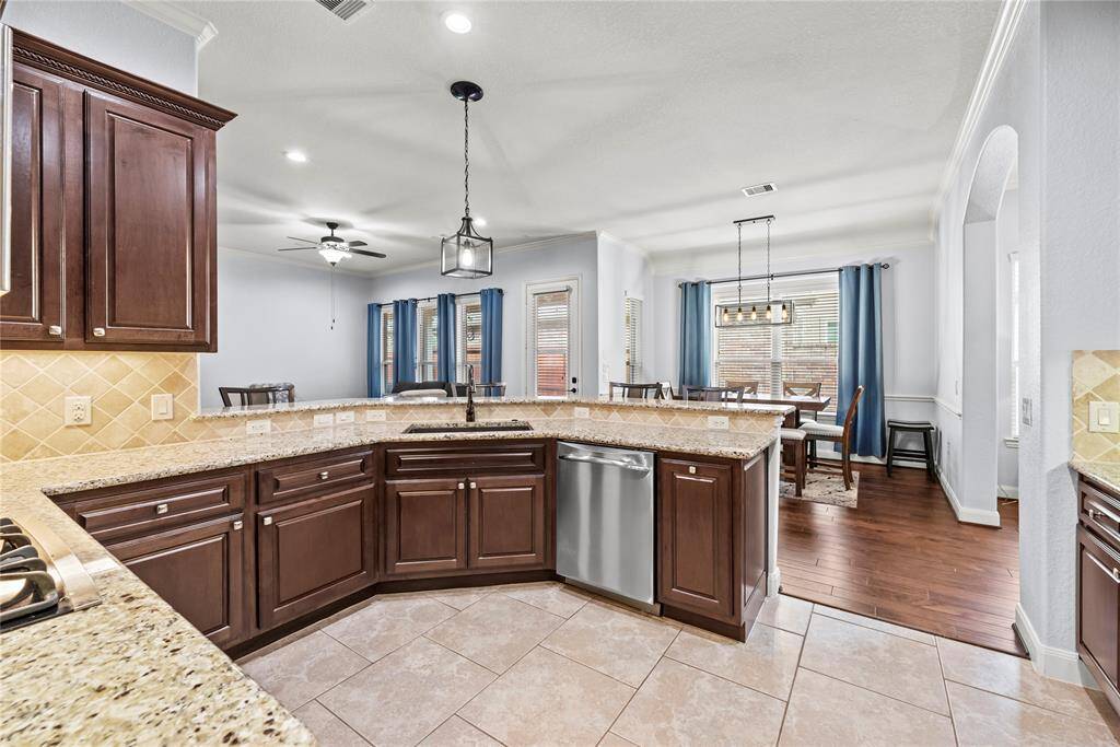 This spacious kitchen offers ample countertop space and cabinetry, with pull-outs, plus a large walk-in pantry. You'll have plenty of room for all your favorite kitchen gadgets here.