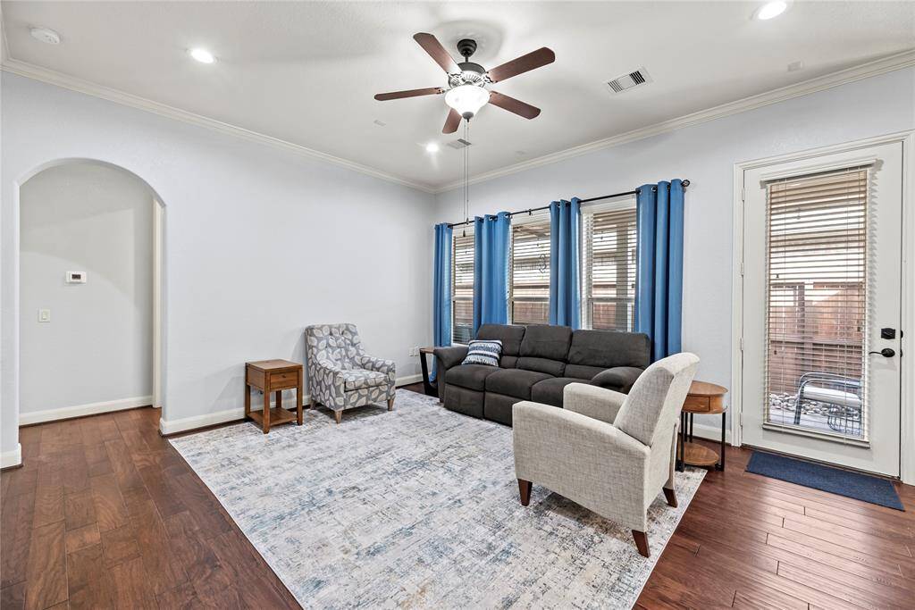 The family room offers ample space for large cushy furnishings so everyone can gather and relax comfortably. A wall of windows and a glass door fill the space with natural light while providing seamless acces