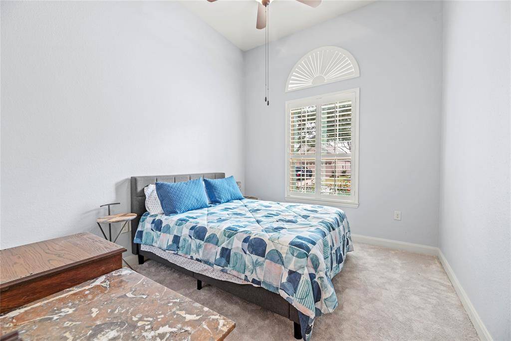 Your guests will rest comfortably in this spacious guest room with soft neutral paint, plush carpet, wood shutters on the windows, recessed lights and a lit fan, a large walk-in closet and easy access to a full bathroom.