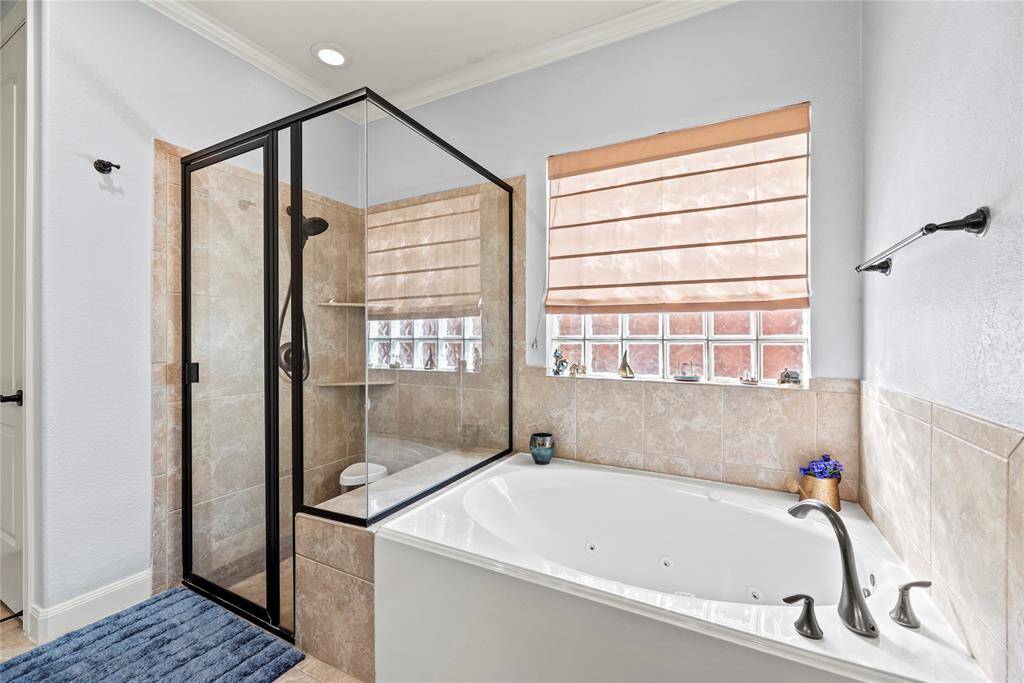 Relax and soak your worries away in this luxurious jetted tub with full tile surround and elegant fixtures. Enjoy this perfect spa-like retreat in the comfort of your own home.