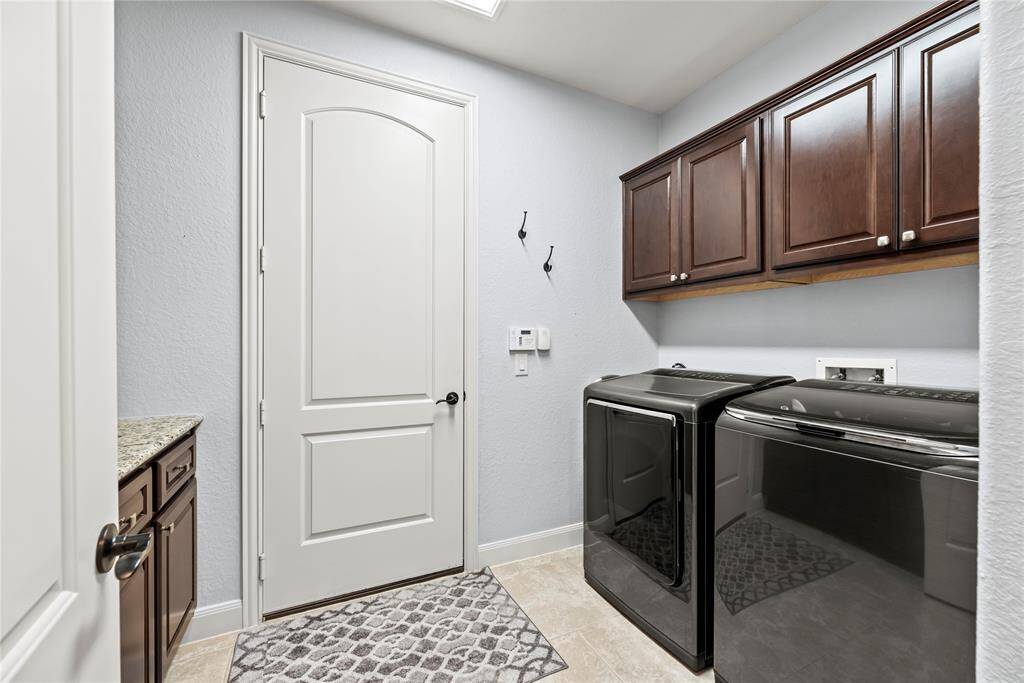 The utility room will make laundry less of a chore. It offers built-in cabinetry for household storage and a convenient folding counter.
