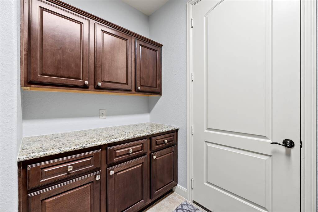 You'll find storage galore in the utility room in addition to a handy folding counter.