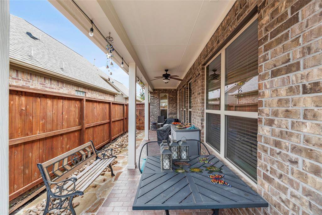 Enjoy your morning coffee or unwind with a nightcap on the covered patio, featuring tile flooring, a lit ceiling fan, and ample space for your grill and outdoor seating. The patio has been thoughtfully extended with beautiful flagstone, creating even more room for entertaining and outdoor enjoyment.