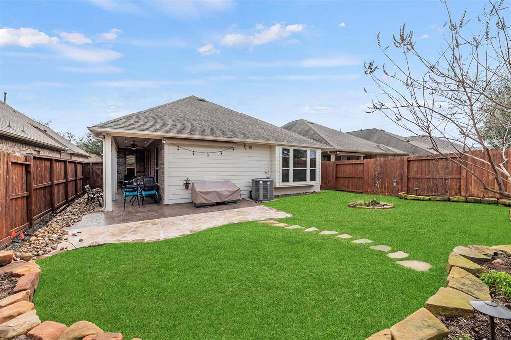 Enjoy summer BBQs and casual outdoor gatherings with a covered patio, uncovered patio extension, and spacious manicured fenced yard with a sprinkler system for easy care. A handy awning over the back patio will also provide more shade when needed.