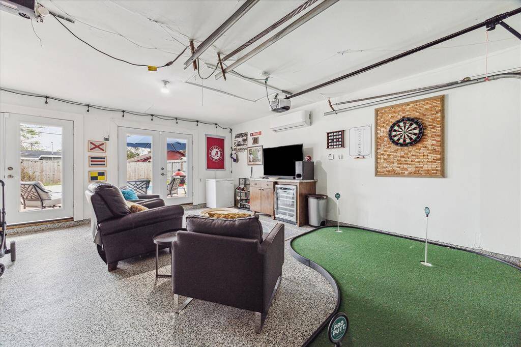 This climate controlled, 2 car garage does double duty and is a fantastic place to relax or entertain! Two sets of double doors open onto the patio and two sets of overhead doors open onto the driveway. The epoxy coated flooring is good looking and nice underfoot.
