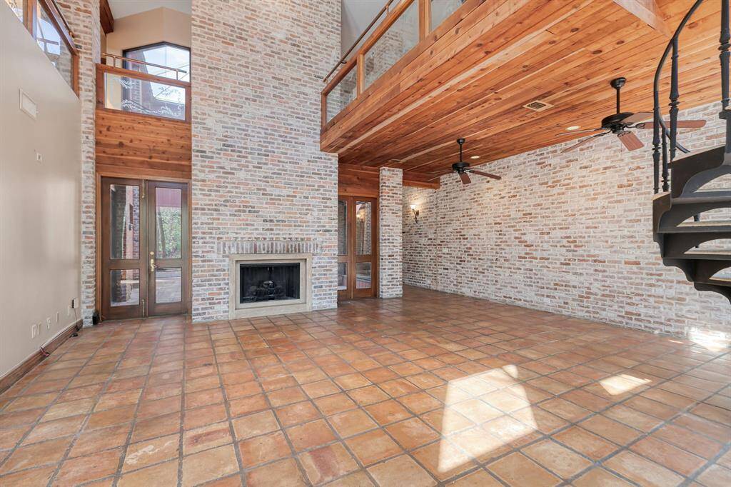 with a fireplace and huge walls for art work display