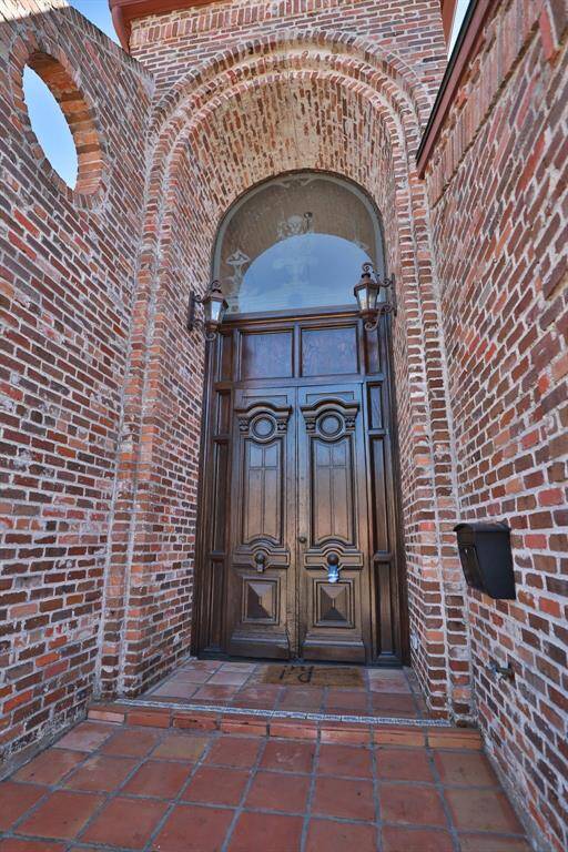 fabulous huge antique front door with hatched glass above it
