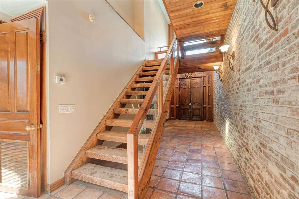 main stair case steps are made from  railroad runners  and a long gallery wall with special lightings