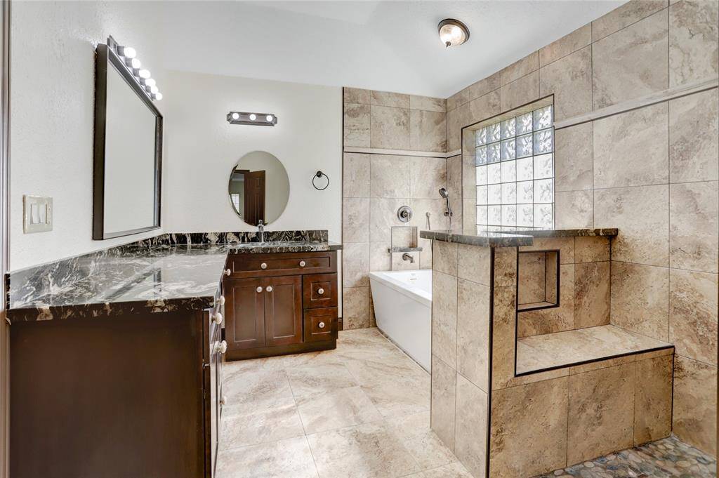 Updated primary bathroom with separate tub and shower.