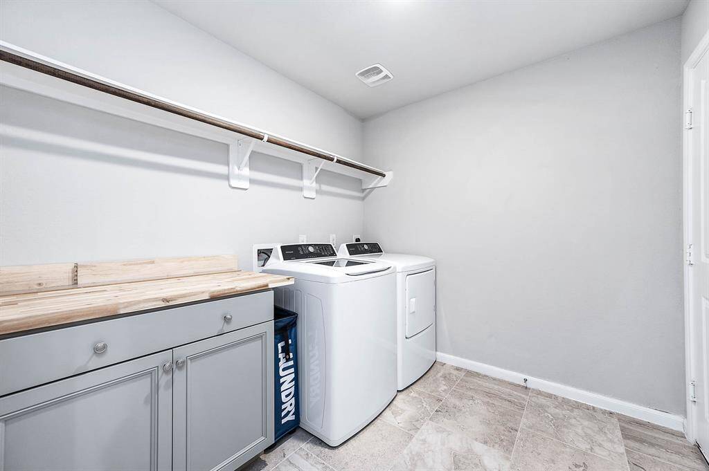 Indoor utility room with a built in cabinet and folding table.
