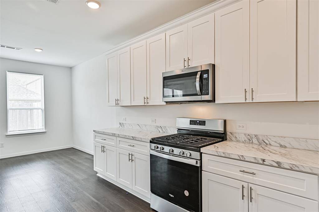 Stainless steel appliances and gas cooktop.
