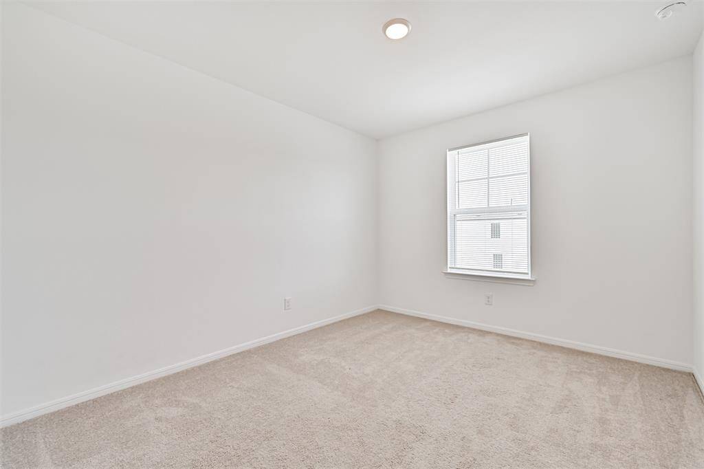 Cozy fourth upstairs bedroom with natural light.