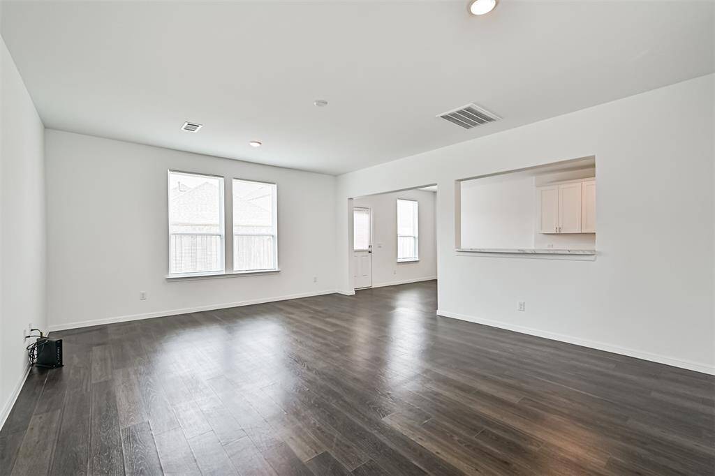 First-floor layout featuring an open-concept living and dining area, a well-appointed kitchen, and a welcoming foyer. Perfect for modern living and entertaining.