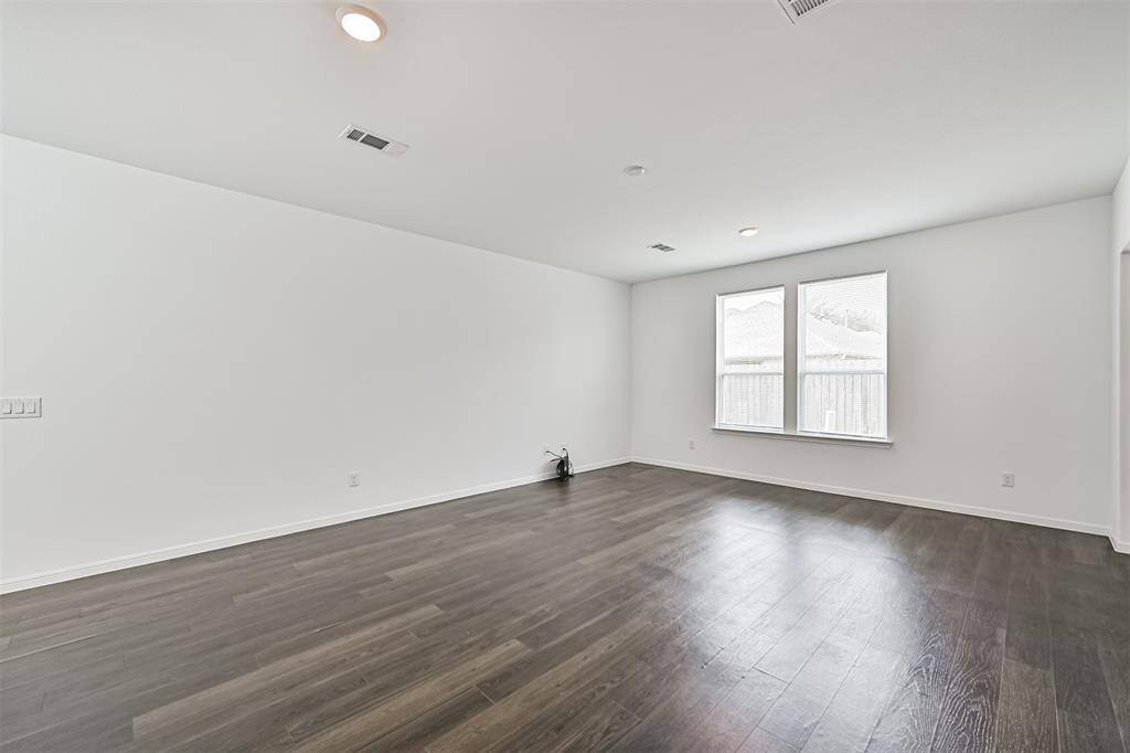 Home features vinyl flooring downstairs and lots of natural light throughout.