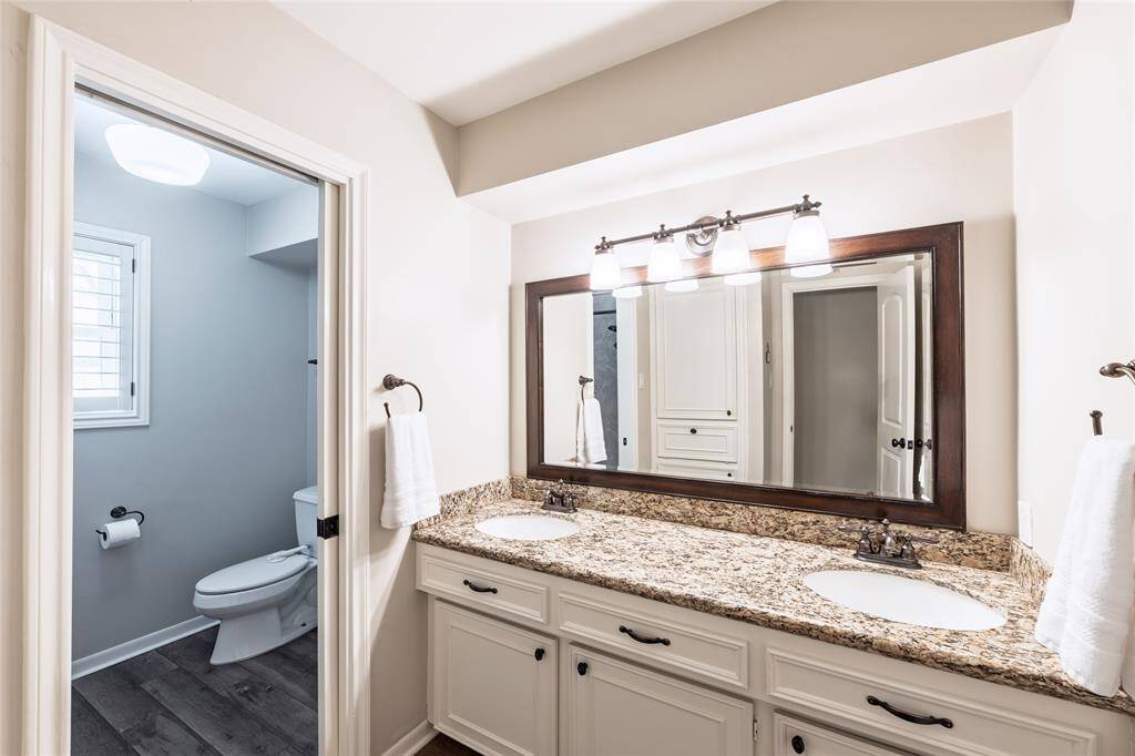 Hall bathroom offers a pocket door for added privacy for multiple users.