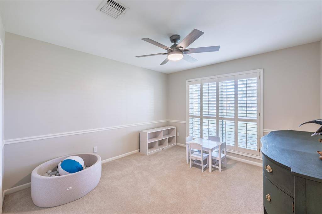 Secondary Bedroom 3 with views of the front yard. All secondary bedrooms feature ample closet space.