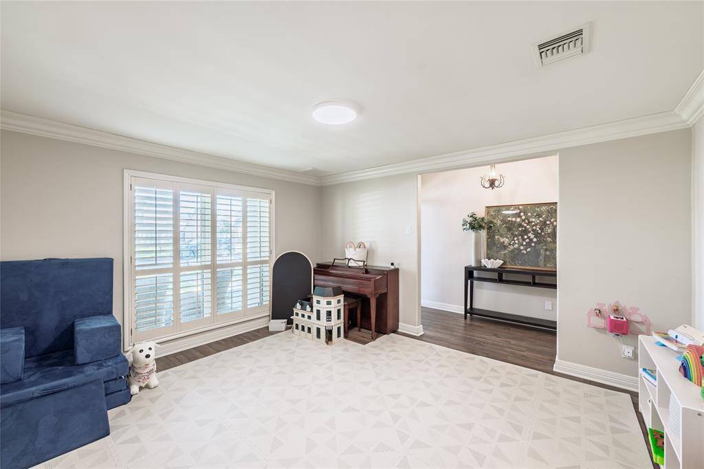 The formal dining room, currently utilized as a play room, provides an inviting atmosphere just off of the entry.