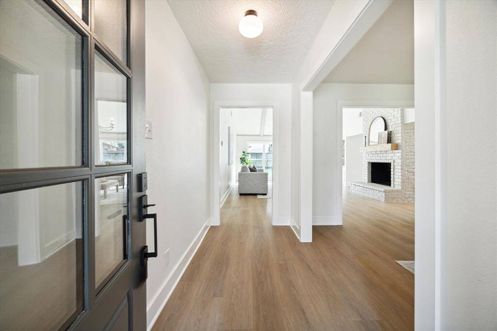 THE ENTRANCE HALL IS WELCOMING WITH DESIGNER PICKED "EVERGREEN" LUXURY VINYL PLANK FLOORING WHICH CONTINUES THROUGHOUT THE MAIN LIVING AREAS.