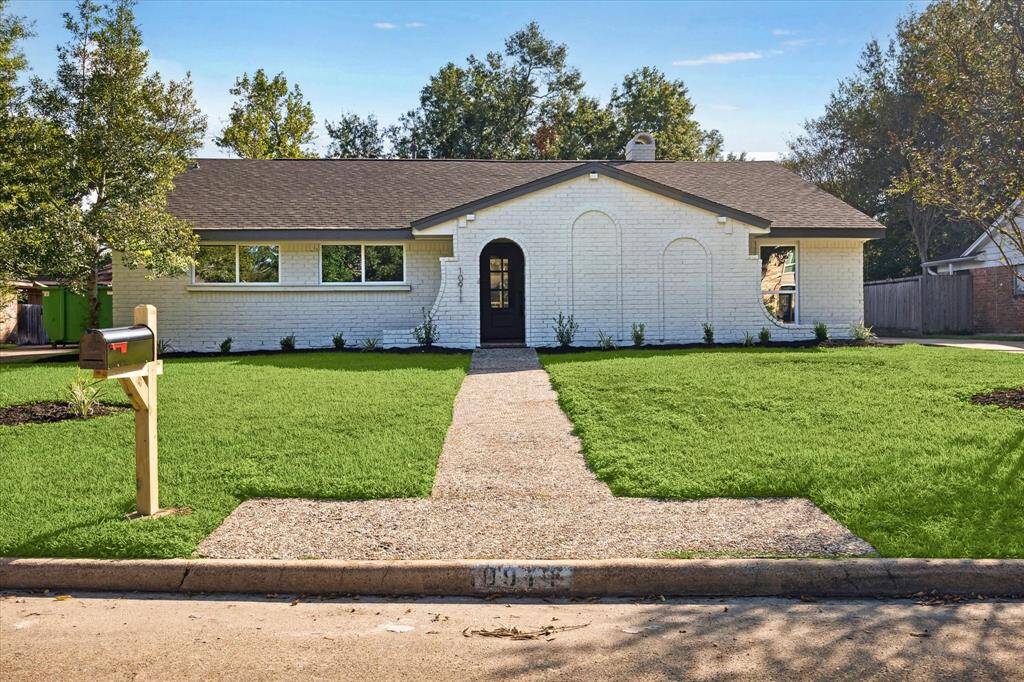 THE HOME FEATURES A LUSH FRONT YARD WITH MANICURED LAWN AND FRESH RECENT LANDSCAPING.